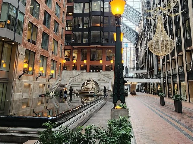 Indoor pedestrian street with brick walls, lamps, and a fountain