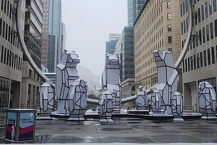 White geometric animal sculptures displayed outdoors under The Ring