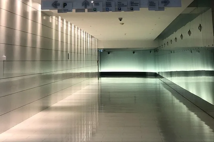 Empty modern underground corridor with tiled walls and floor